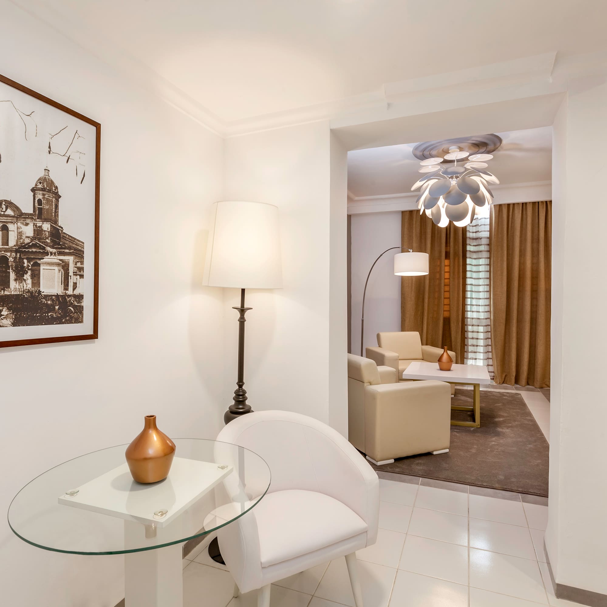 a room with a glass table and a lamp