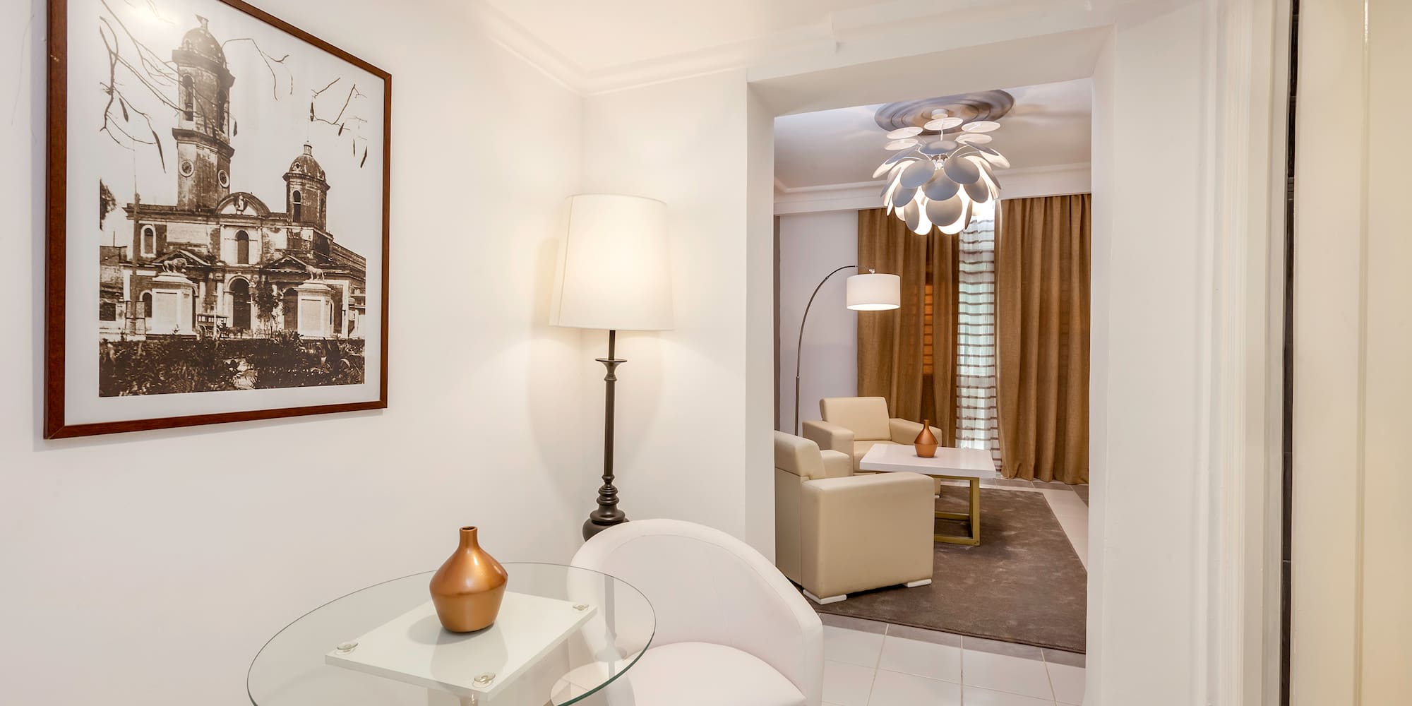 a room with a glass table and a lamp