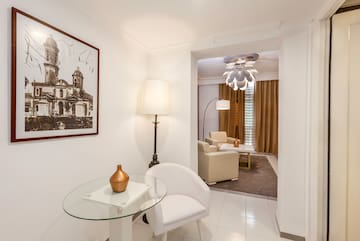 a room with a glass table and a lamp