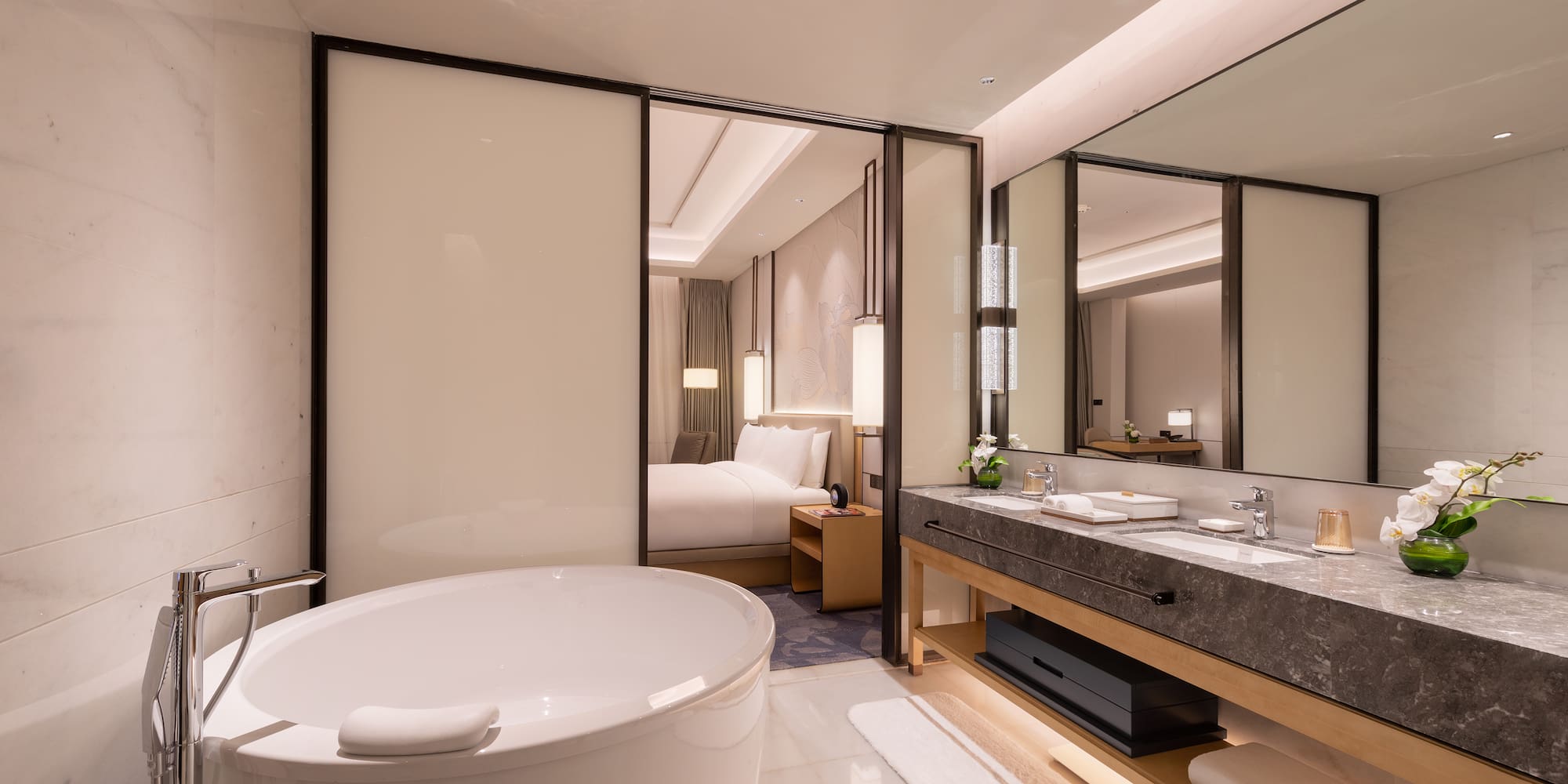 a bathroom with a large tub and a double sink