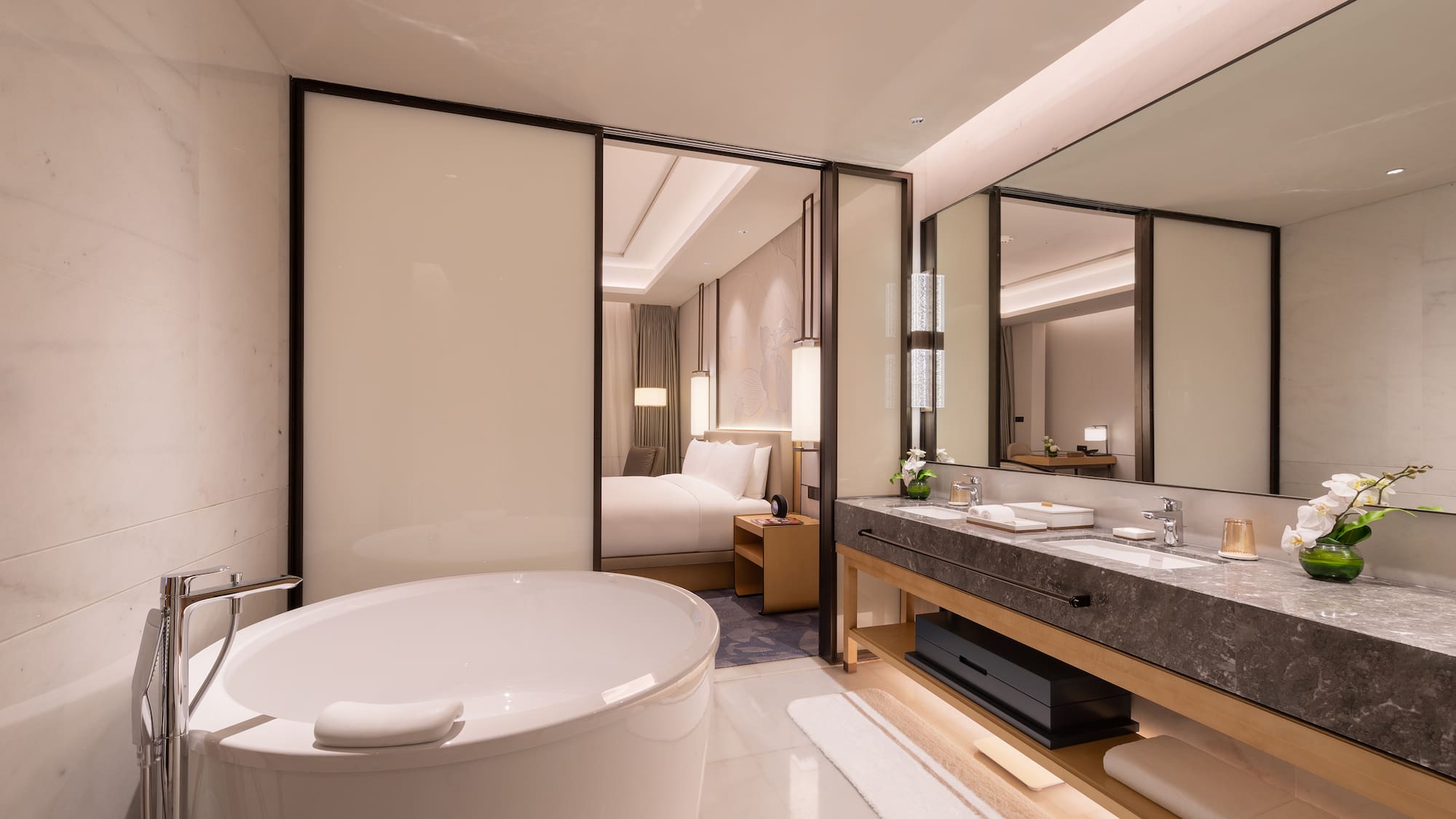 a bathroom with a large tub and a double sink