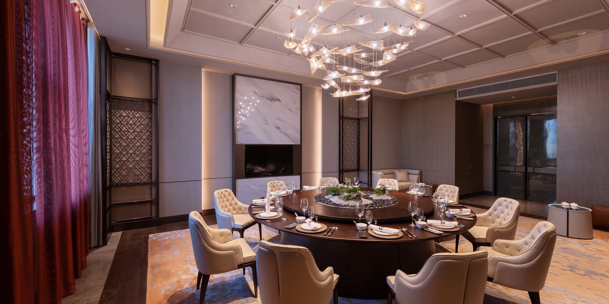 a large round table with a chandelier in a room