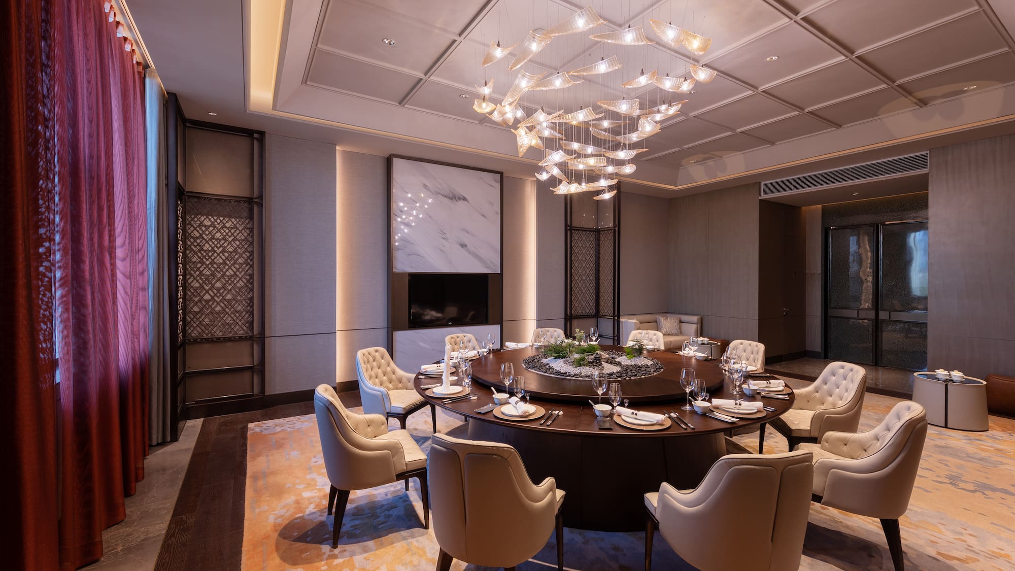 a large round table with a chandelier in a room
