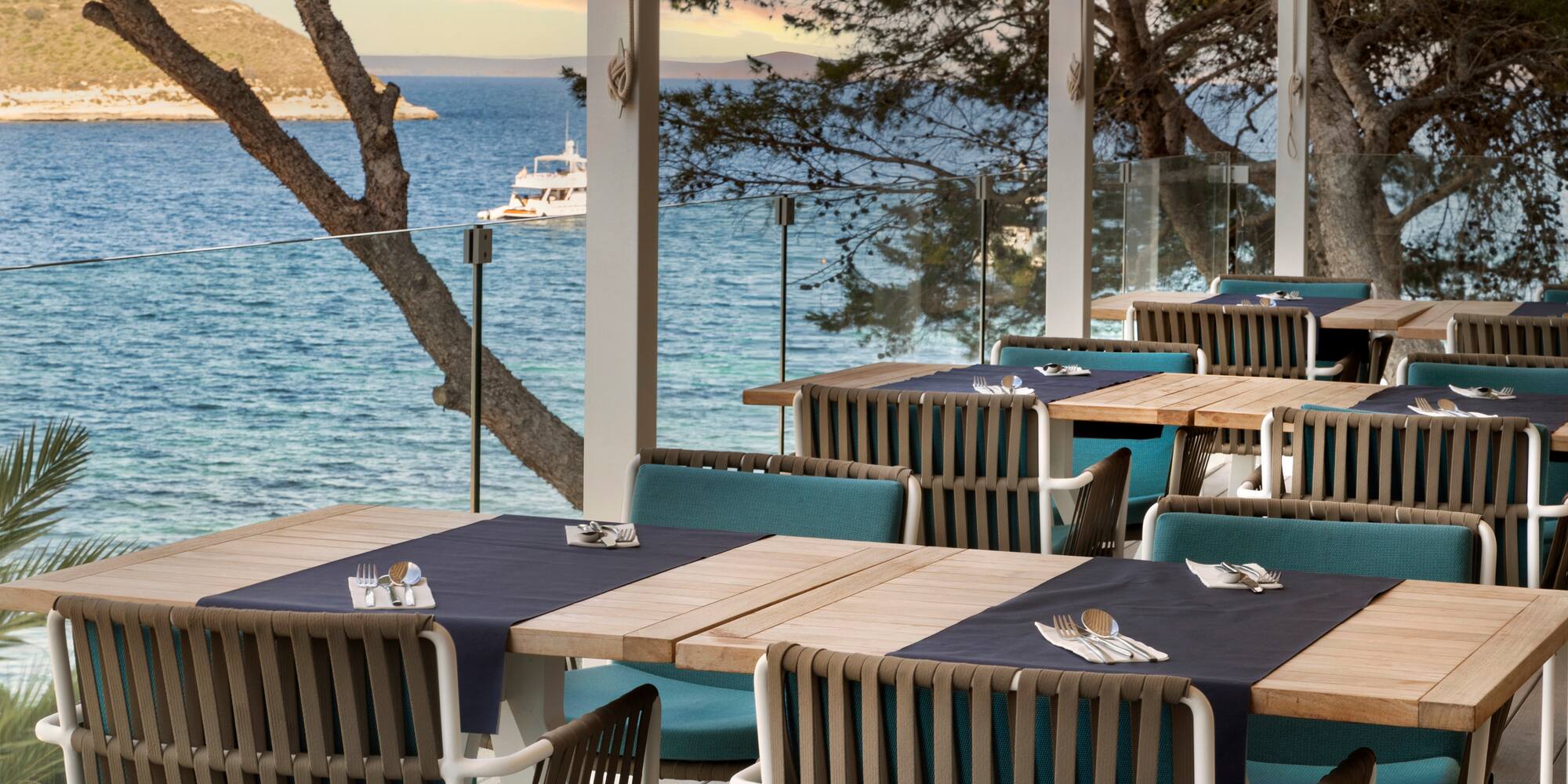 a table set up on a deck overlooking a body of water
