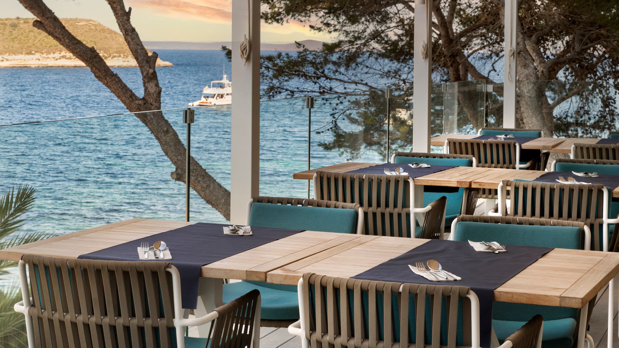 a table set up on a deck overlooking a body of water