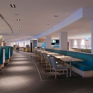 a restaurant with blue booth seating and blue chairs