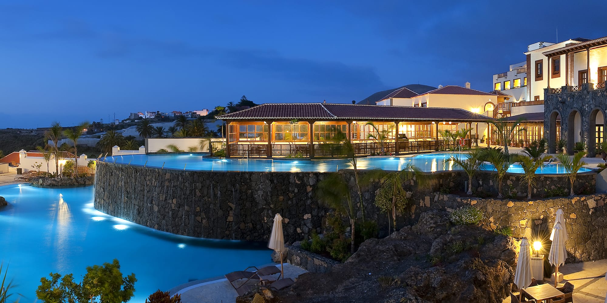 a pool with a building and a building in the background