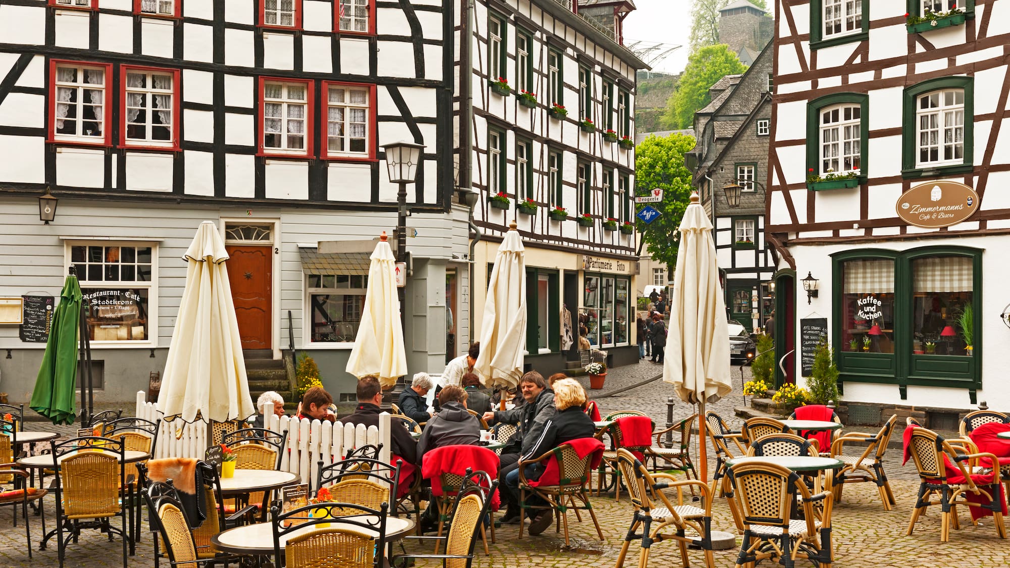 a group of people sitting at tables outside a building