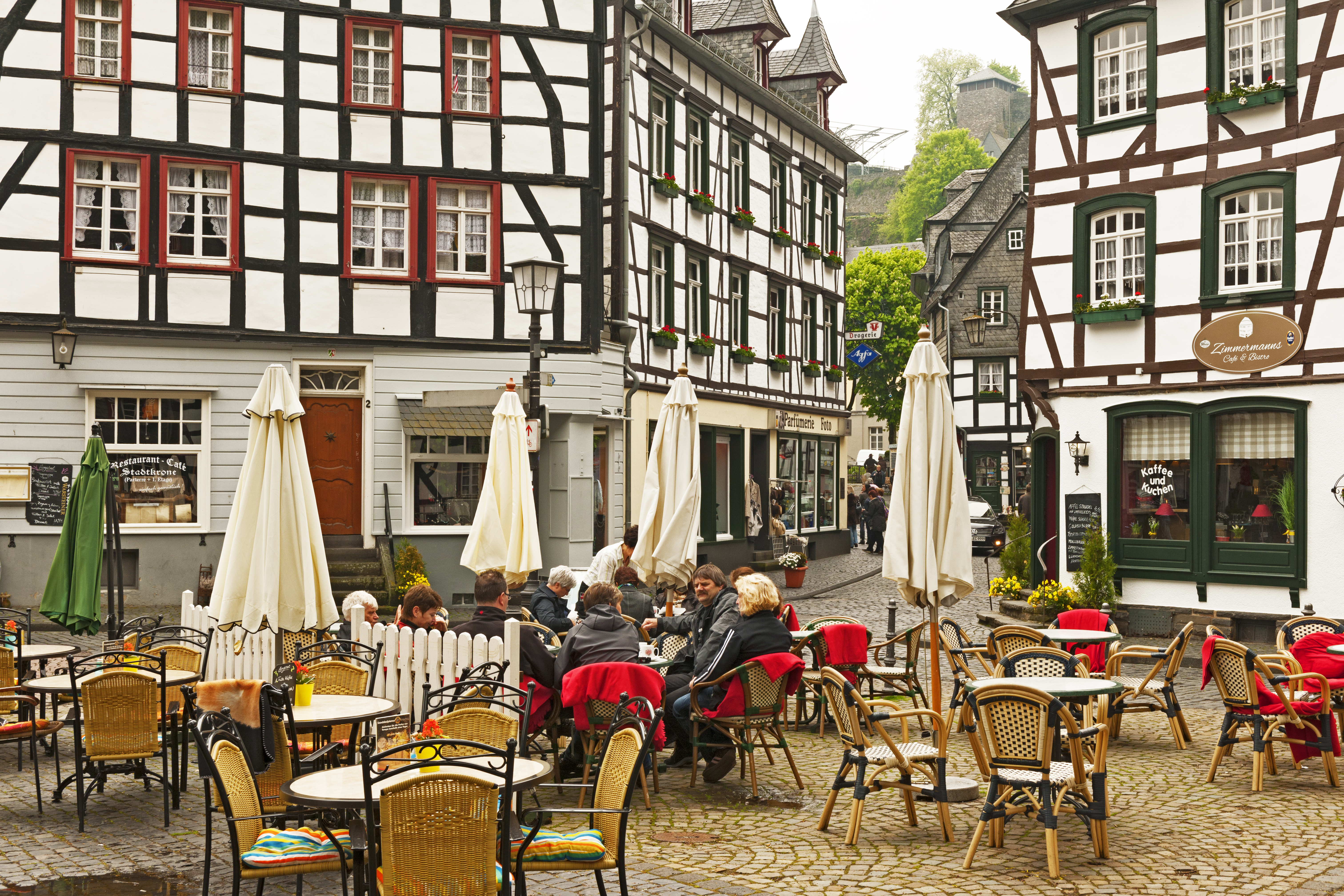 a group of people sitting at tables outside a building