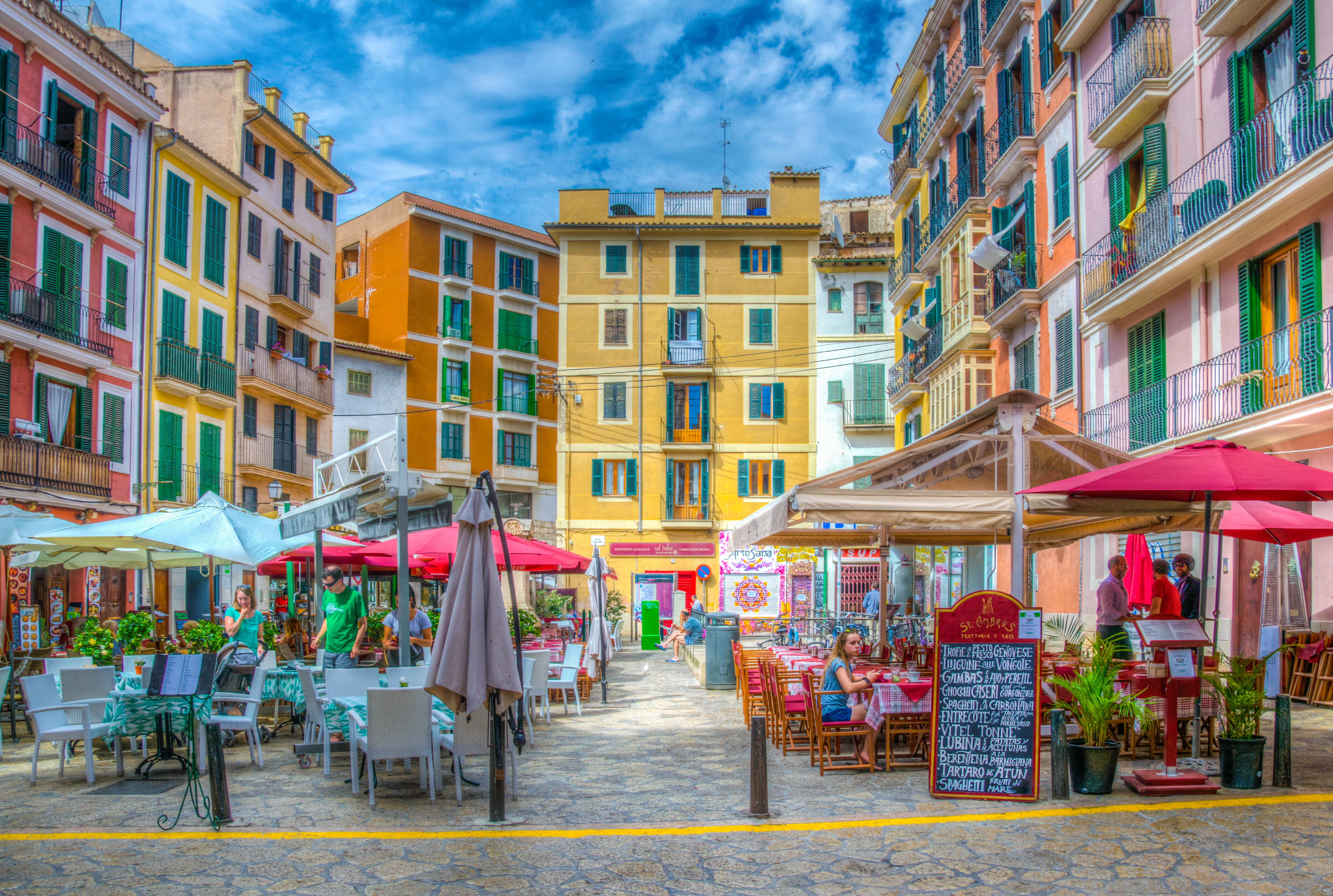 a street with tables and chairs in a city