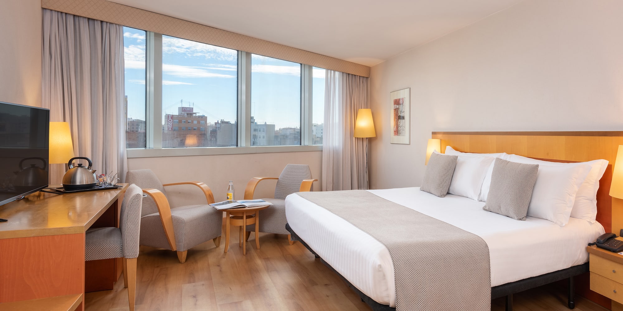 a room with a bed and chairs