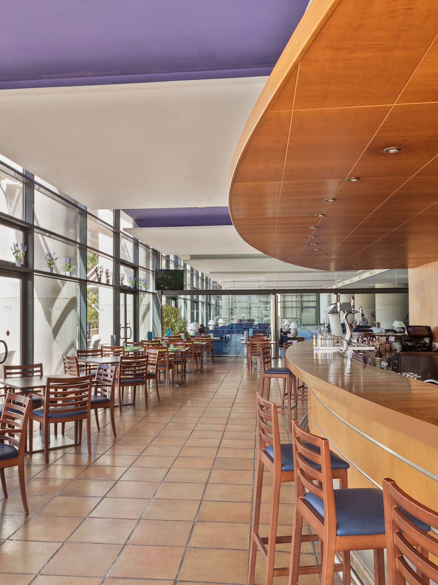 a room with a bar and chairs