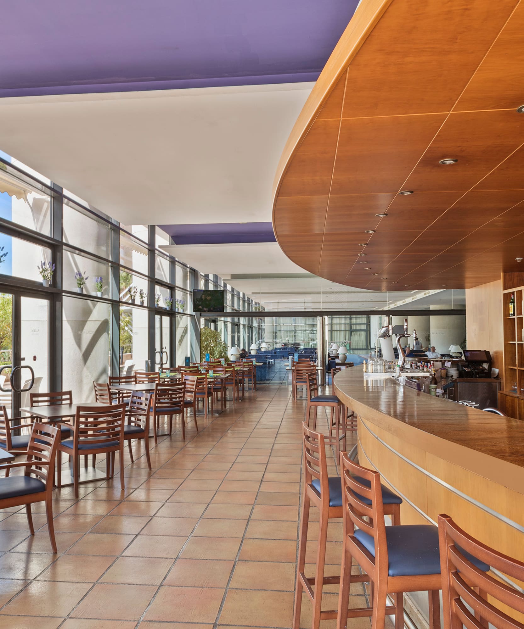 a room with a bar and chairs