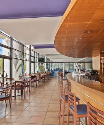 a room with a bar and chairs