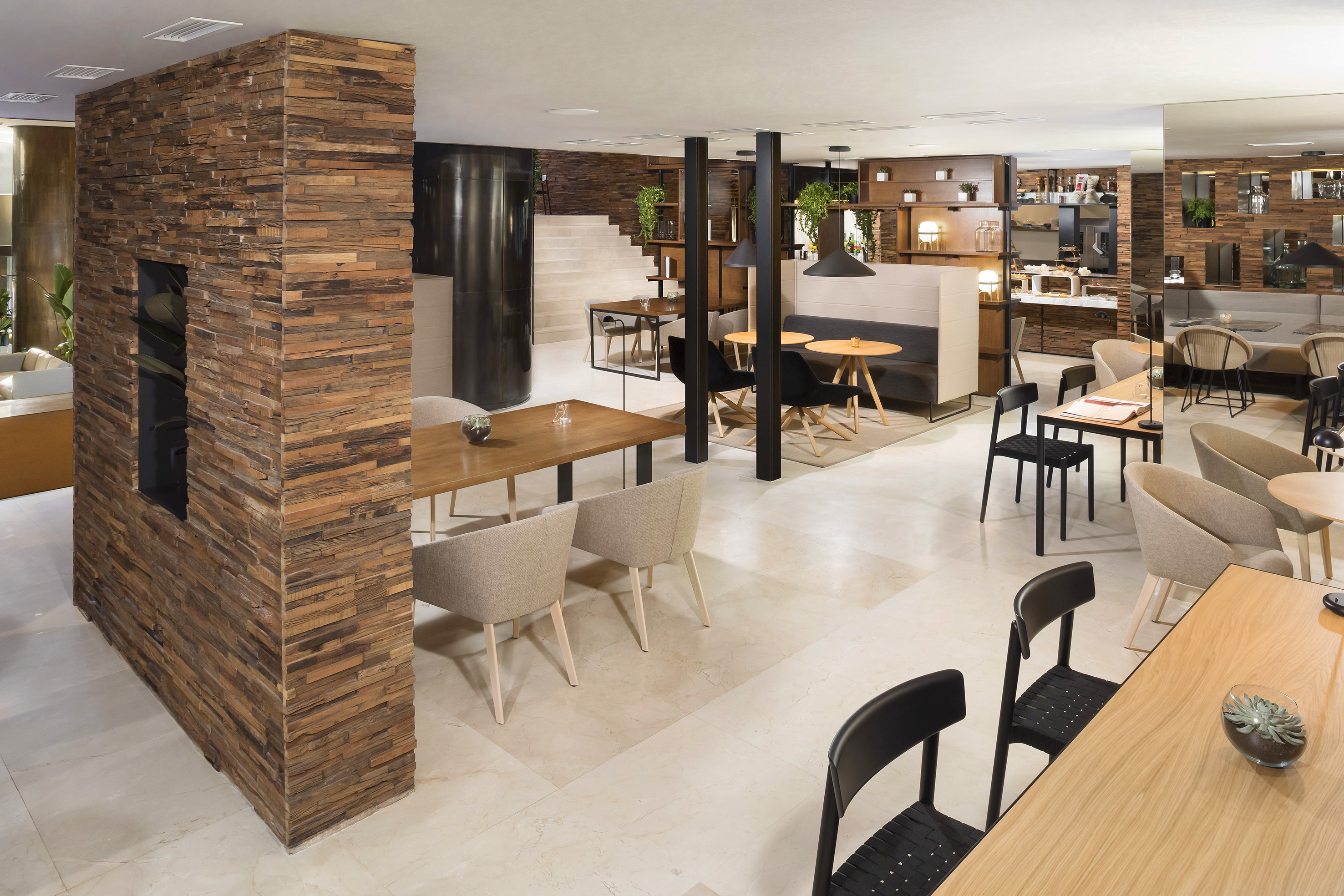 Modern cafe and restaurant with wooden walls, varied seating, and modern design.