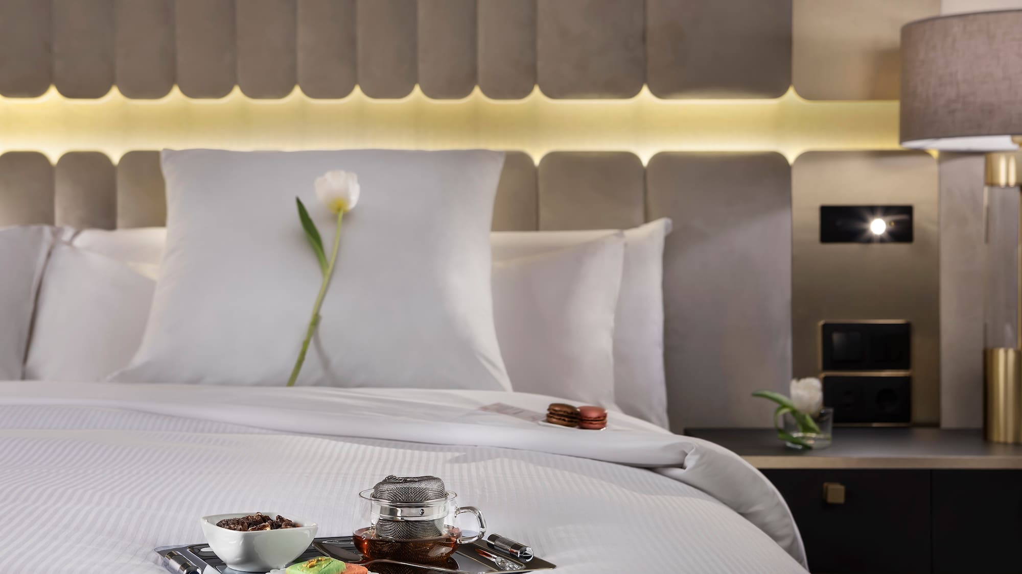 a tray of food on a bed