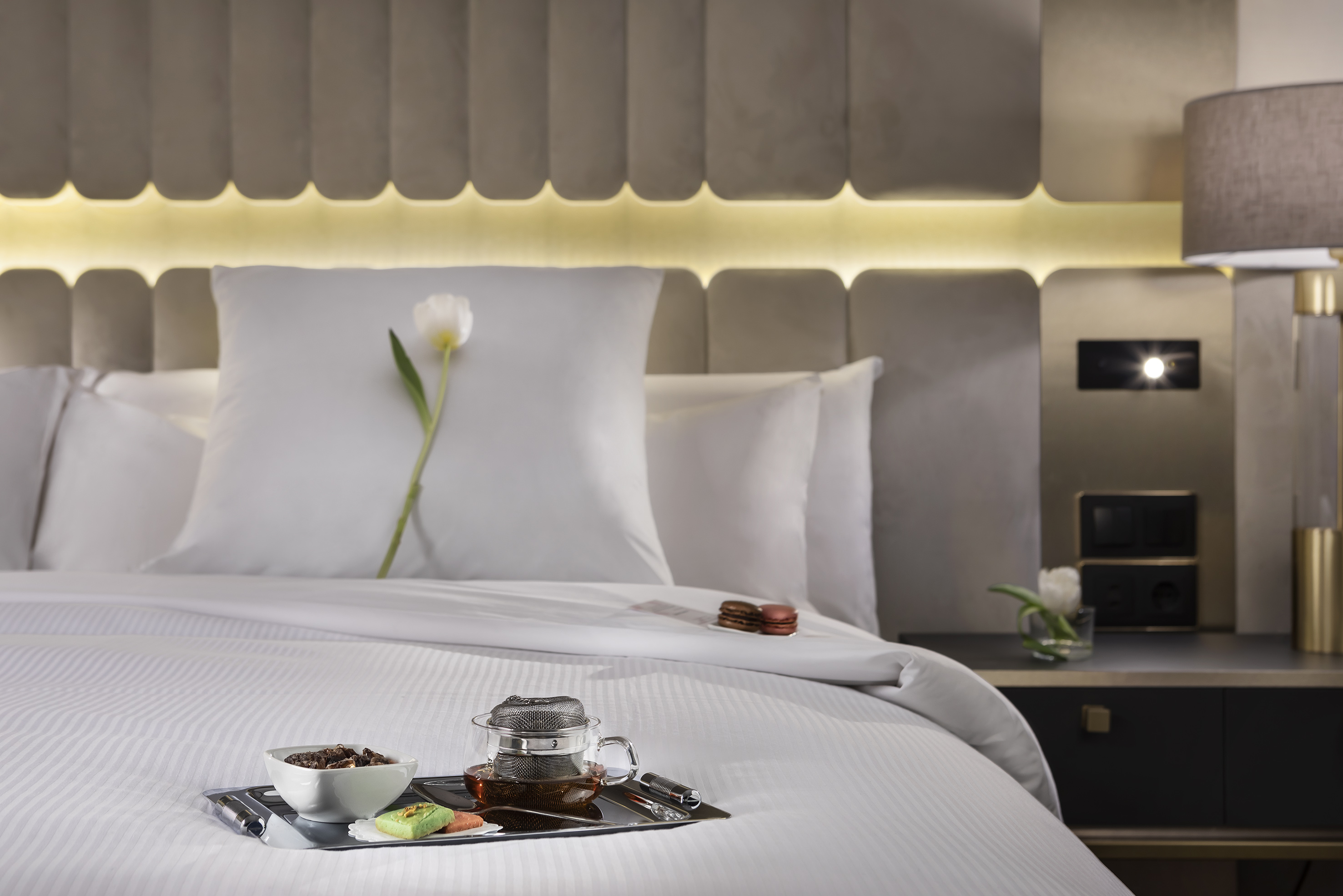 a tray of food on a bed