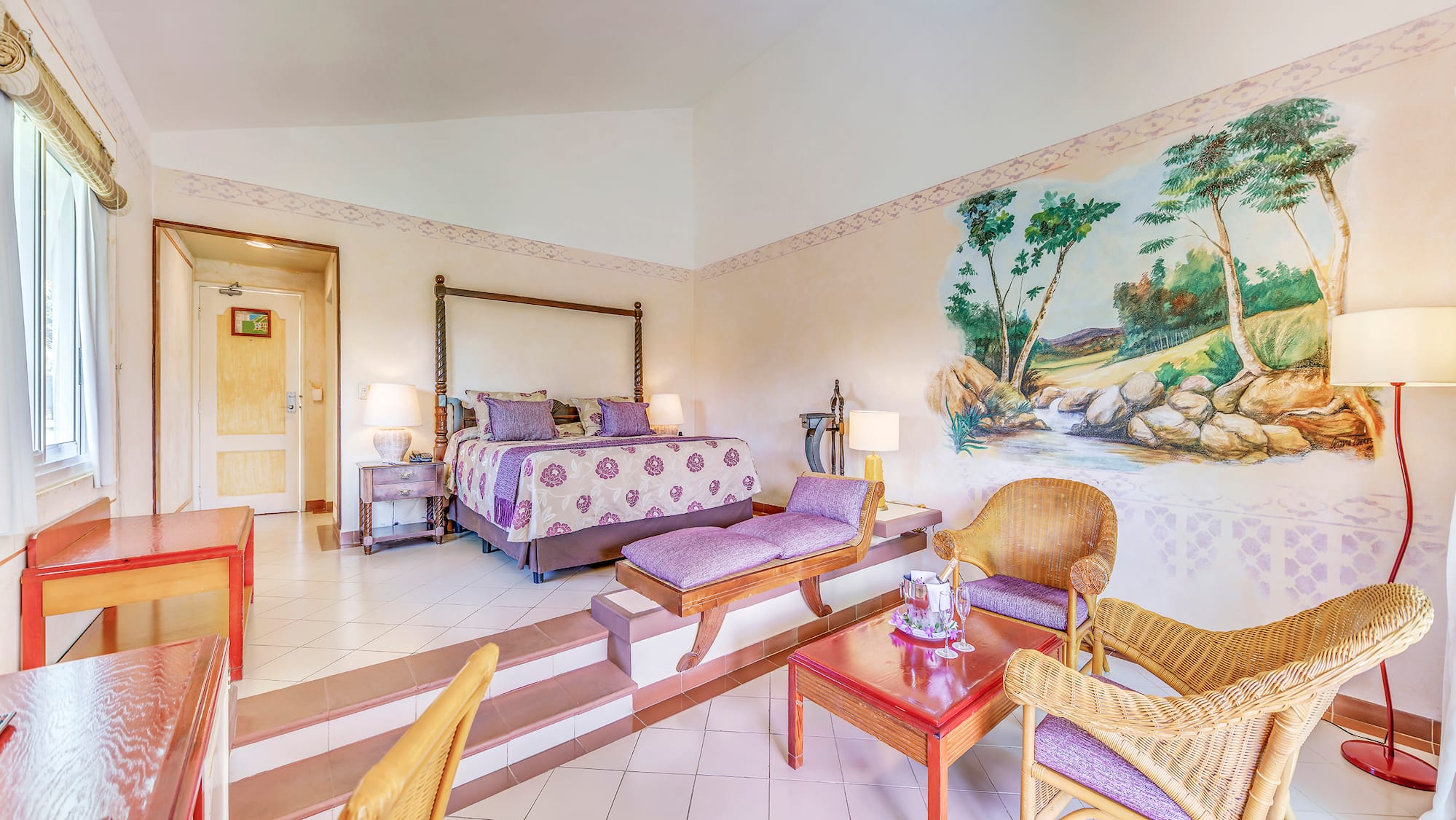 a room with a bed and chairs