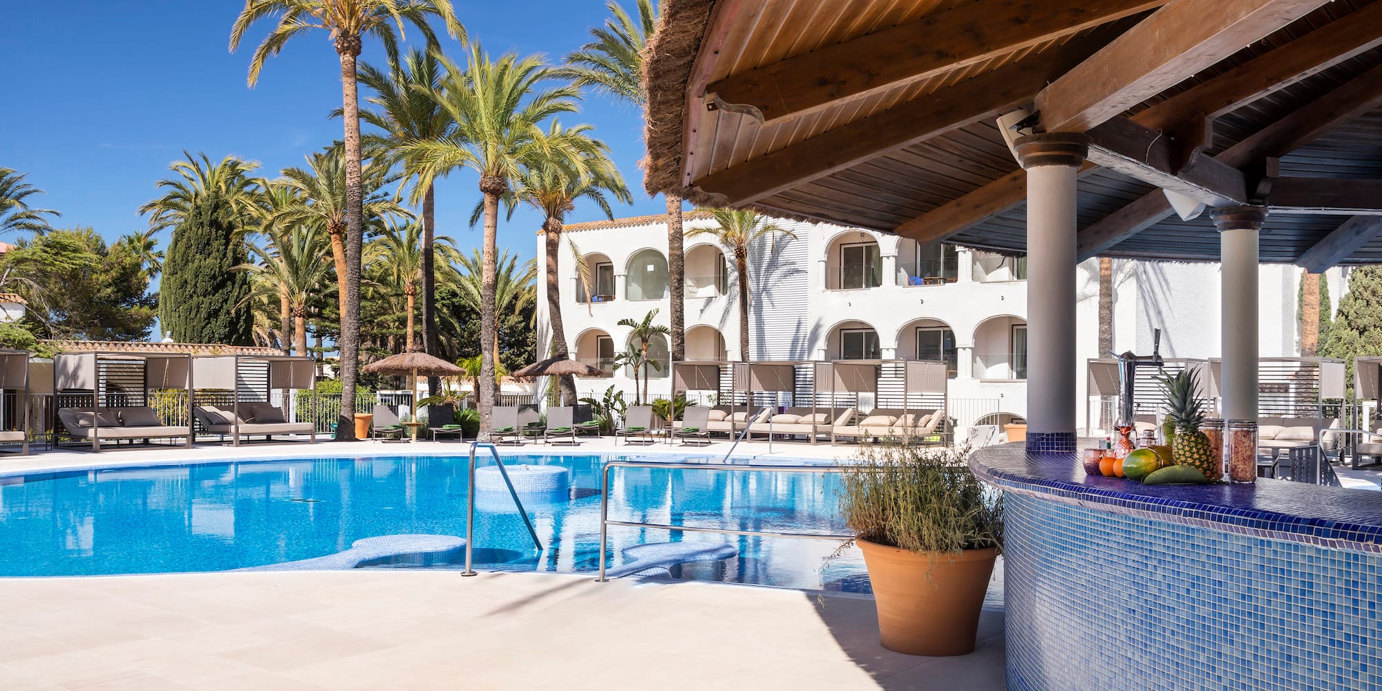 a pool with palm trees and a bar