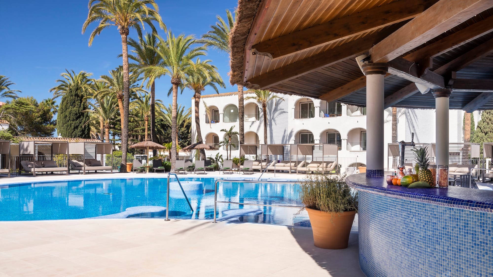 a pool with palm trees and a bar