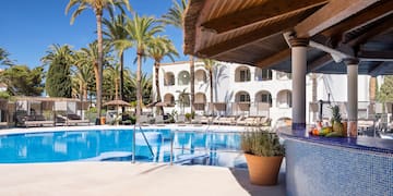 a pool with palm trees and a bar