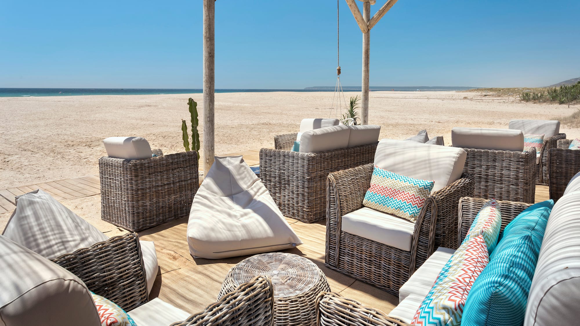 a group of wicker chairs on a beach