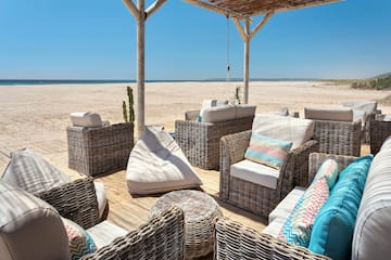 a group of wicker chairs on a beach