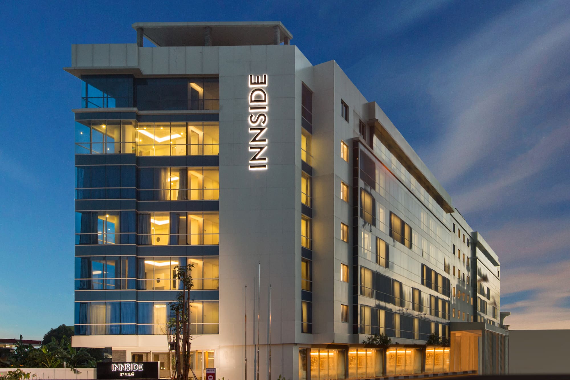 Modern INNSIDE by MELIÁ hotel building exterior lit up at night.