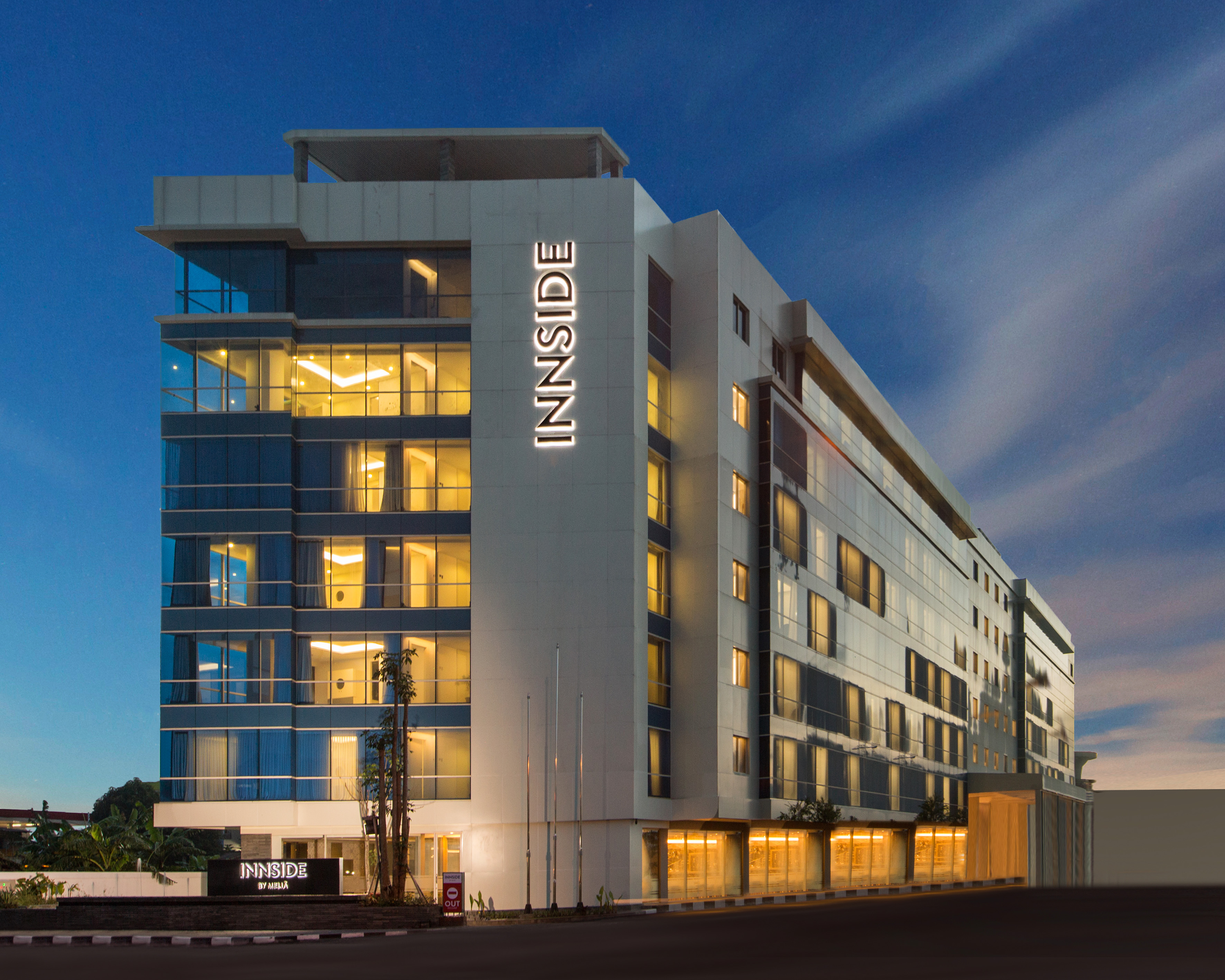 Modern INNSIDE by MELIÁ hotel building exterior lit up at night.