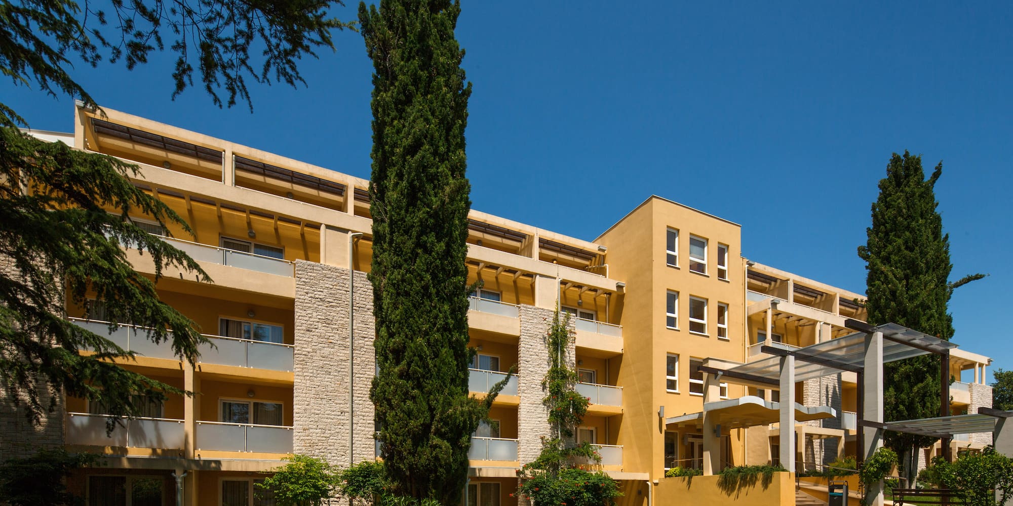 a building with trees and grass