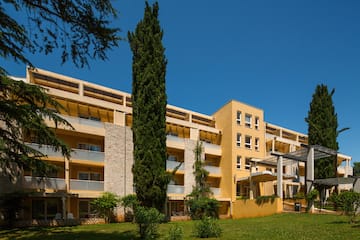 a building with trees and grass