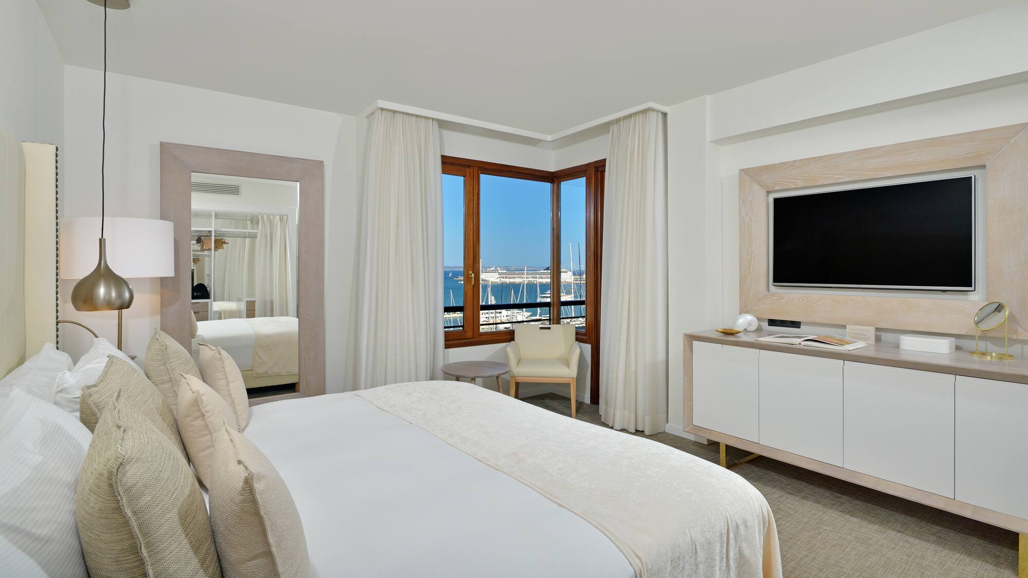 a room with a bed and a television