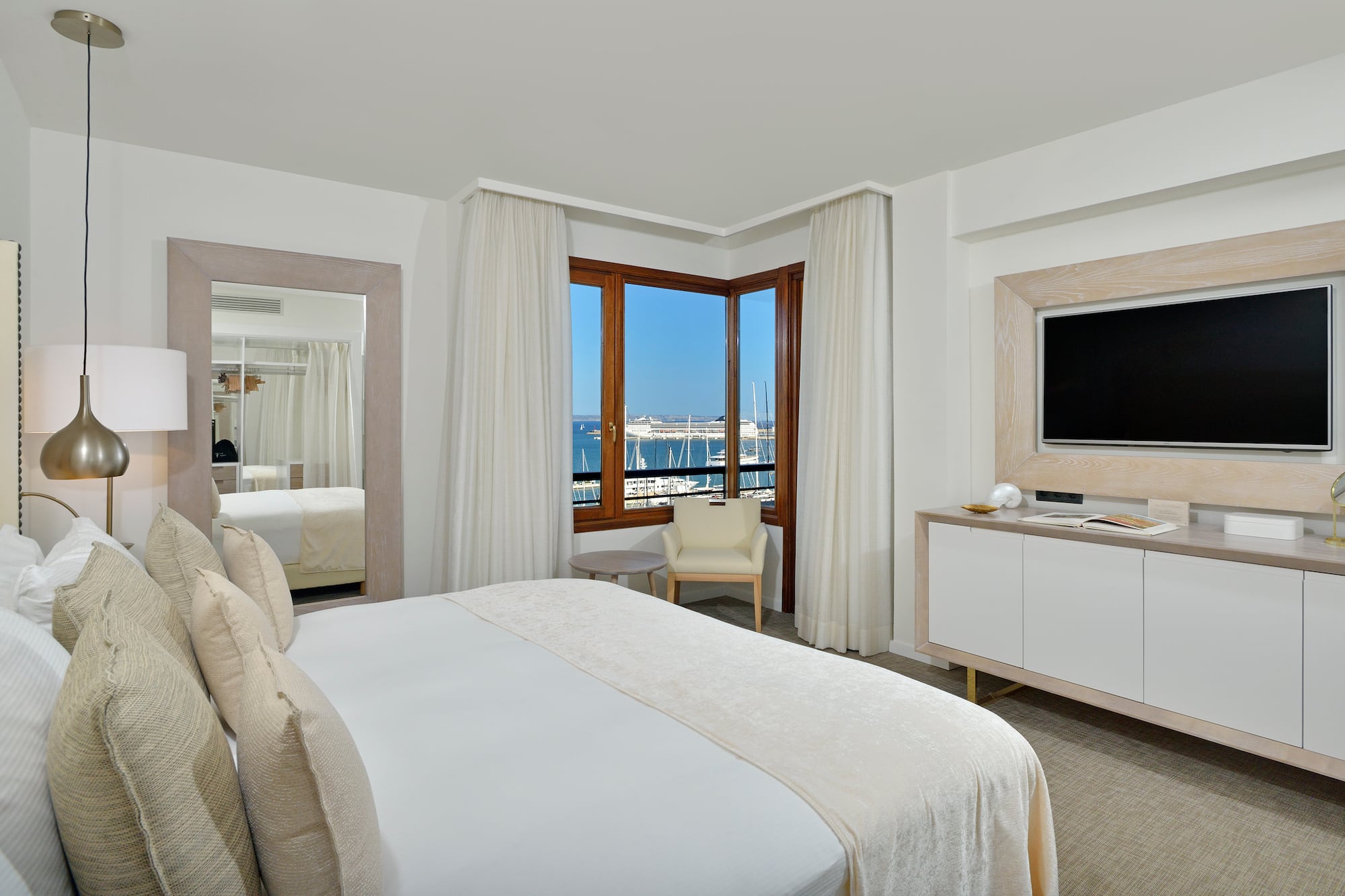 a room with a bed and a television