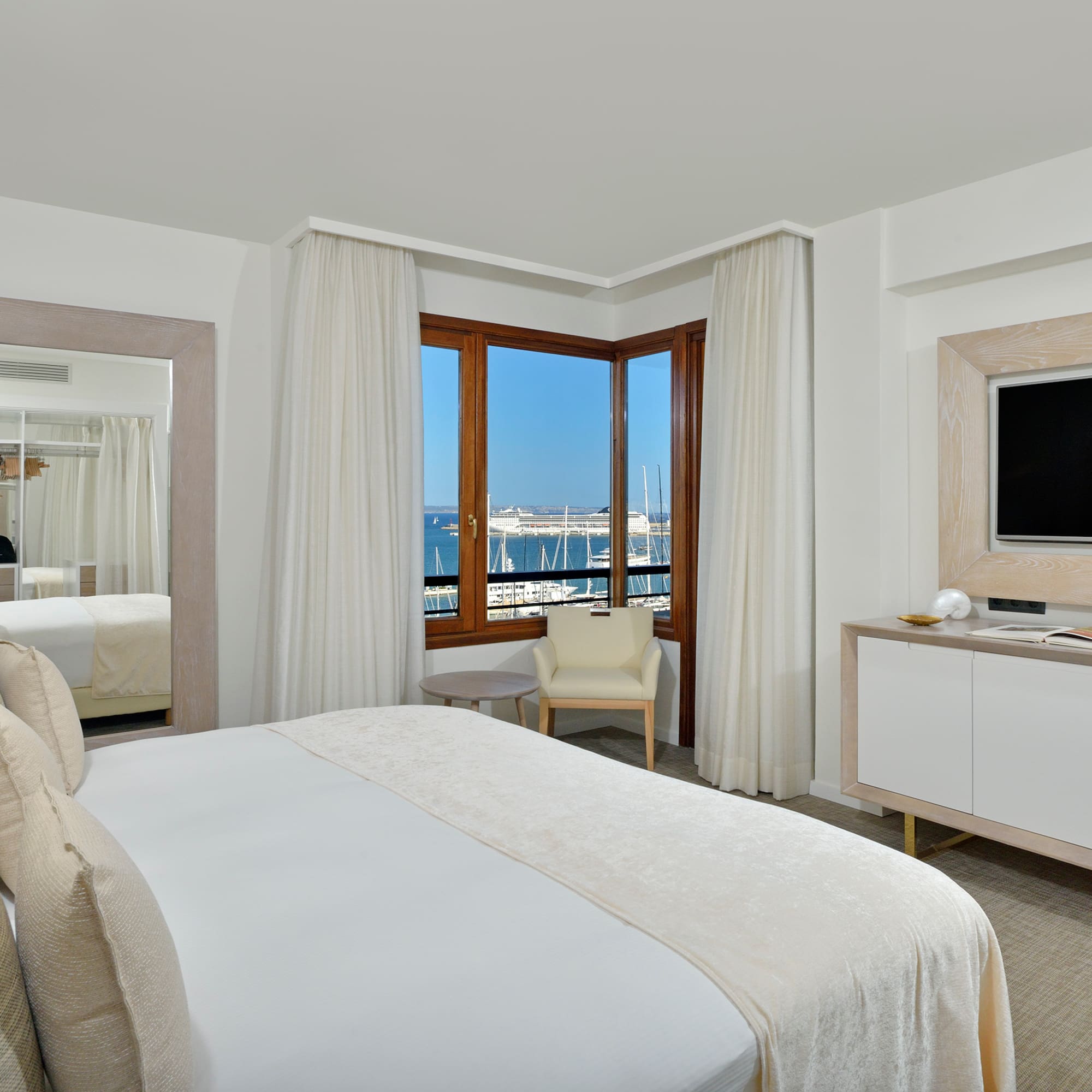 a room with a bed and a television