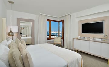 a room with a bed and a television