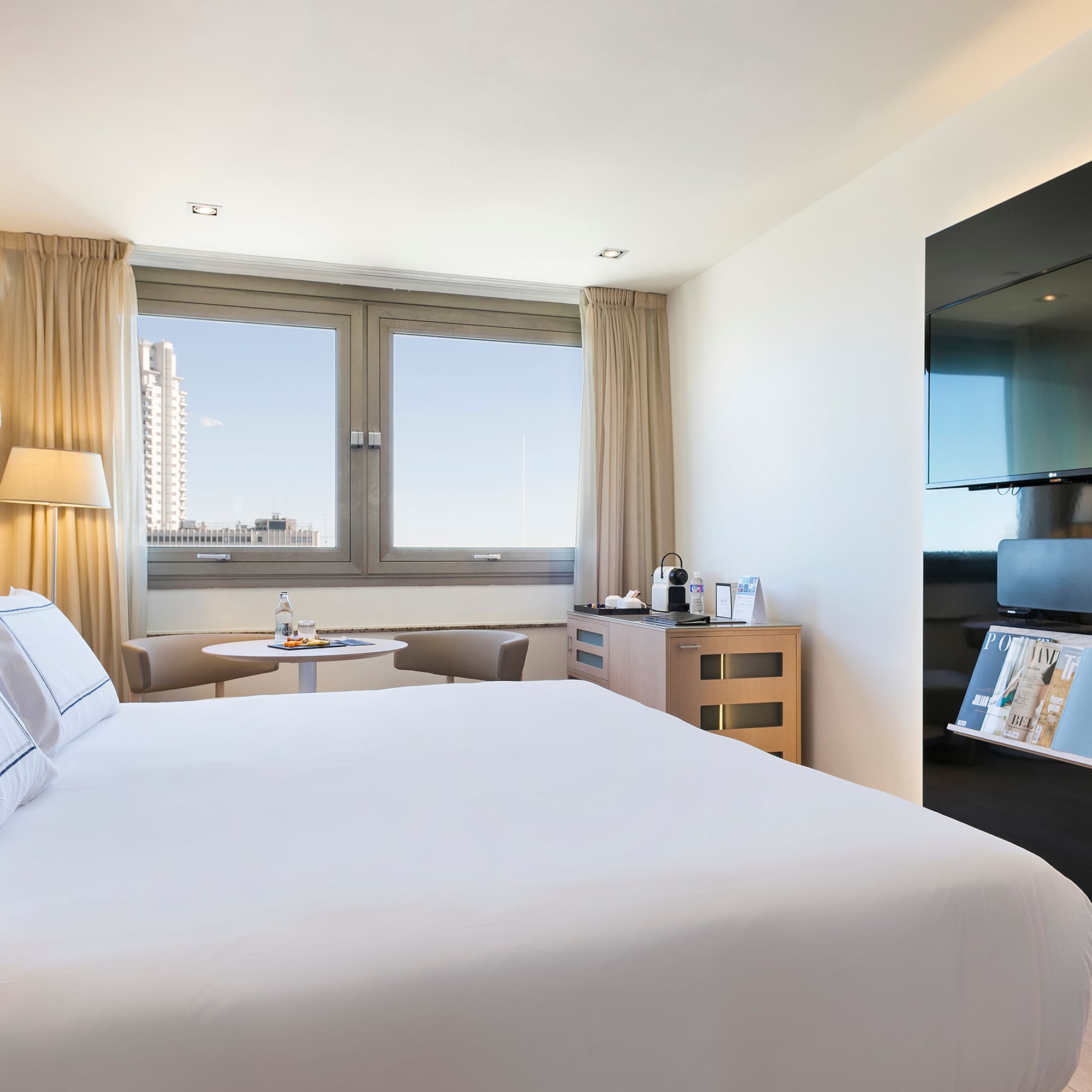 a room with a bed and a tv