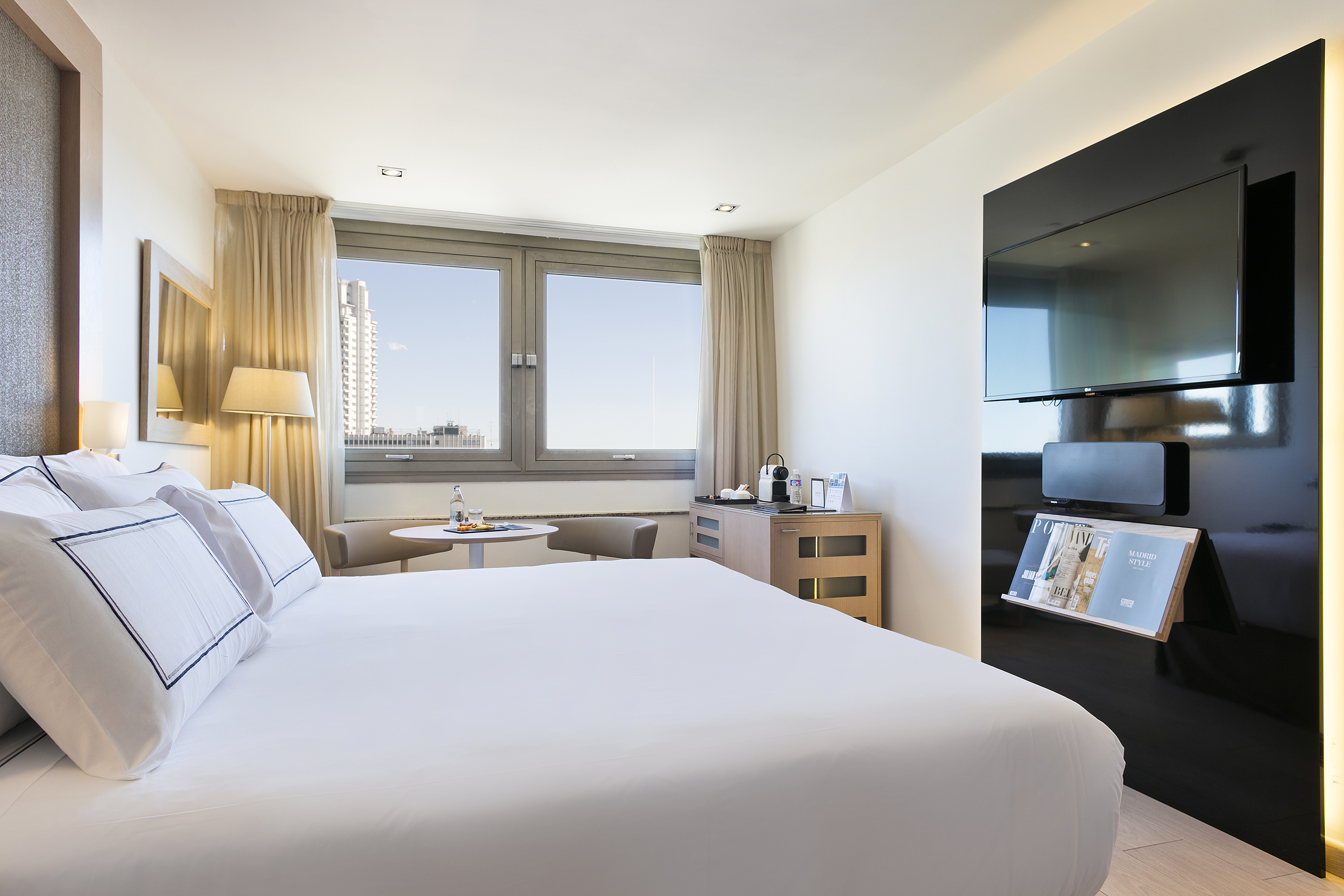 a room with a bed and a tv