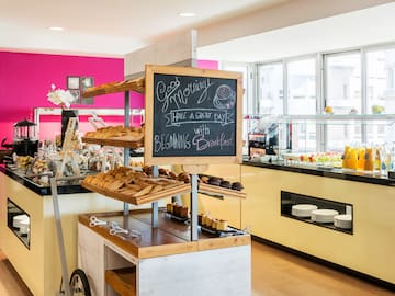 a bakery with a chalkboard on the shelves