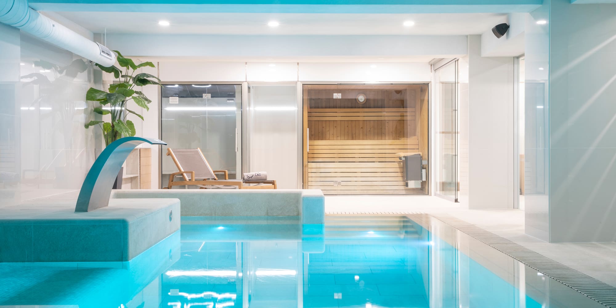 a indoor pool with a waterfall