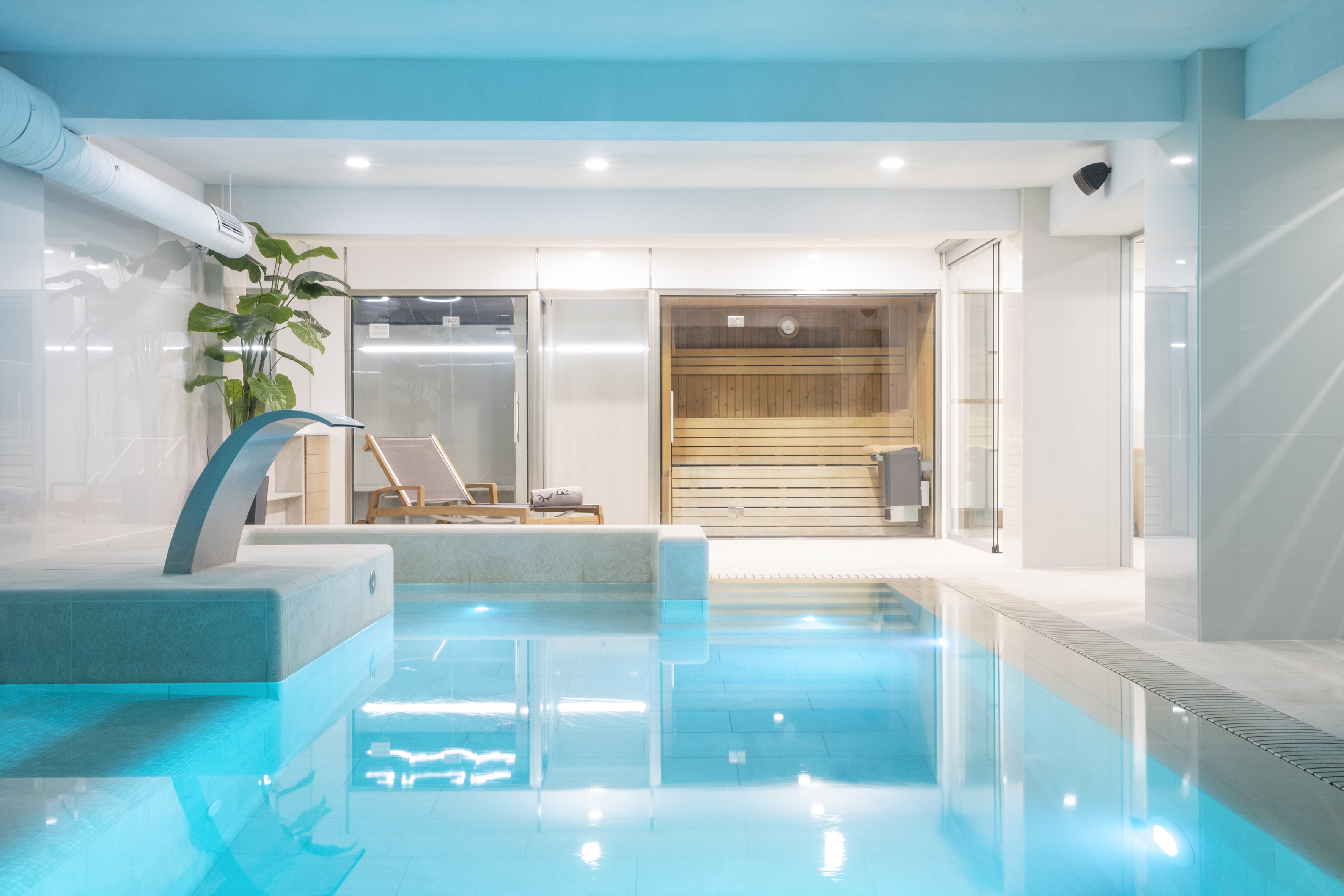 a indoor pool with a waterfall
