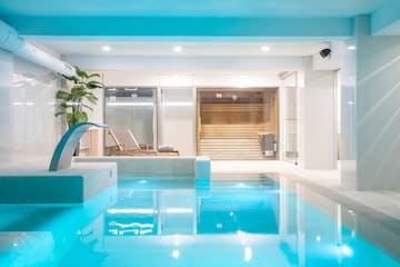 a indoor pool with a waterfall