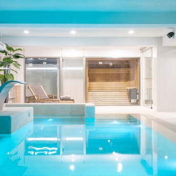 a indoor pool with a waterfall