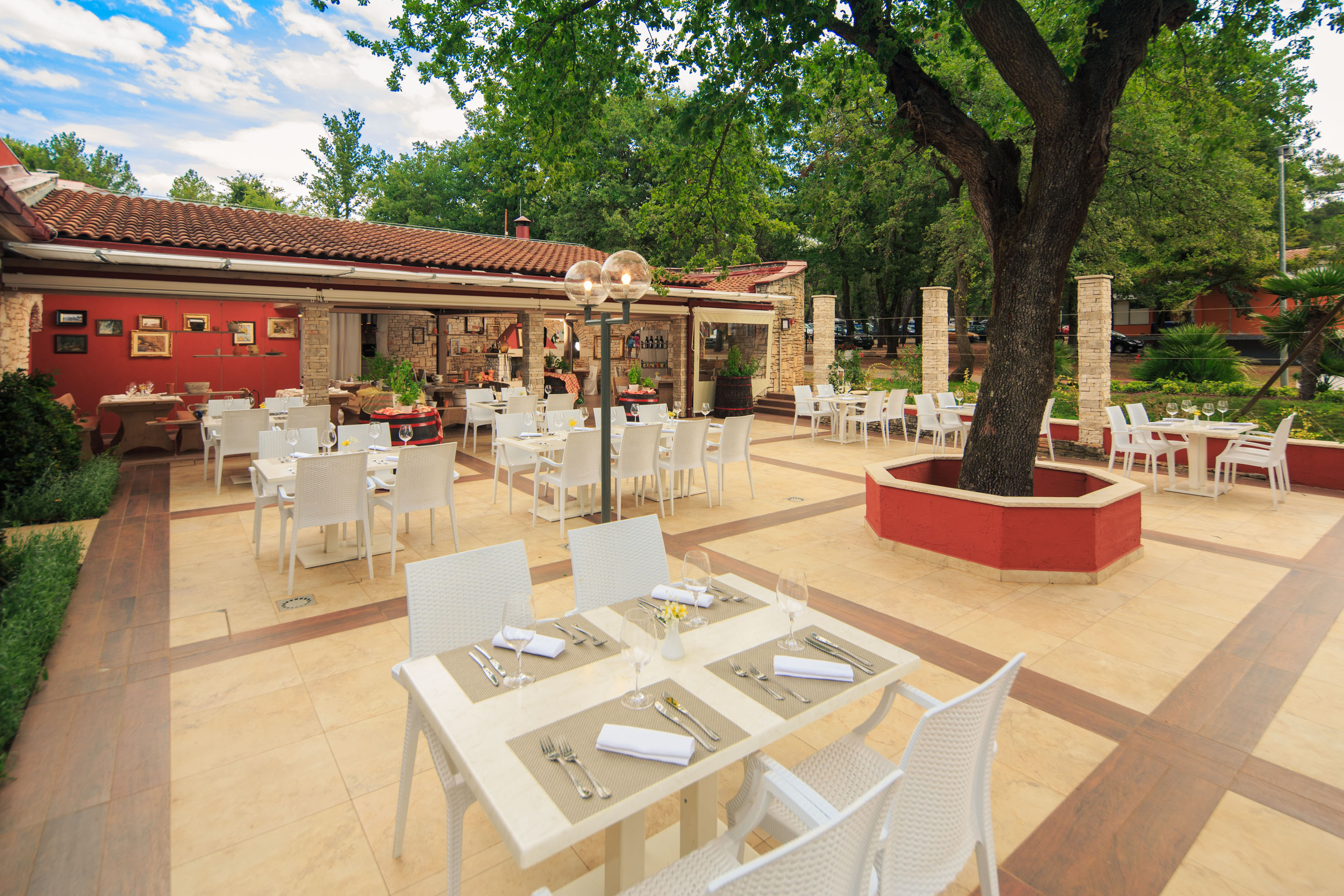 a restaurant with tables and chairs - Á la carte Stella Maris, Lokale Küche - Apartments Stella Plava Laguna Affiliated by Meliá, Umag