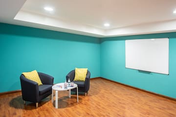 a room with blue walls and a white board
