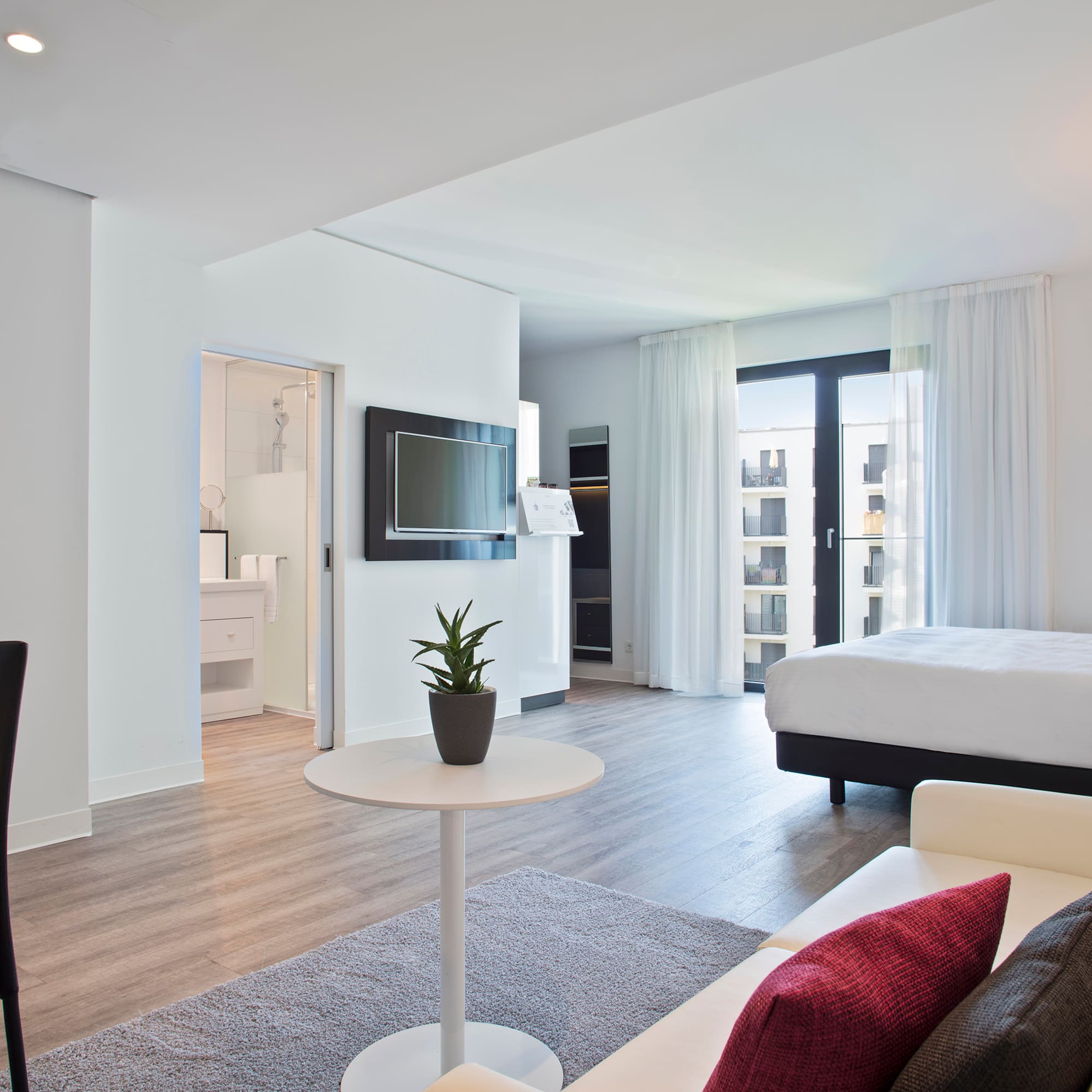 a room with a bed and a tv