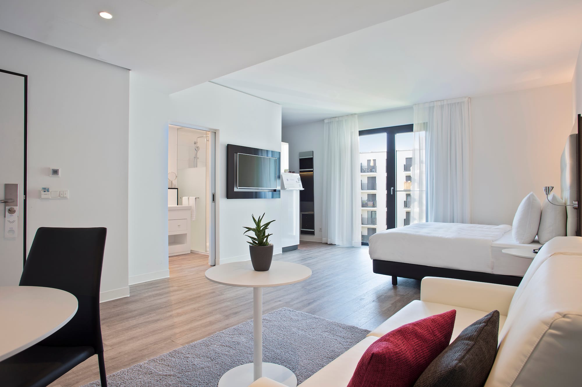 a room with a bed and a tv