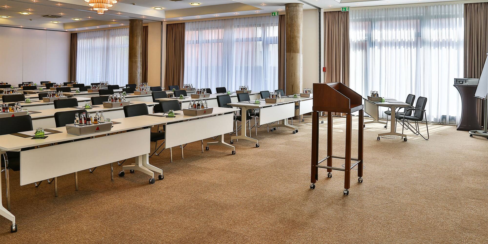 a room with many tables and chairs