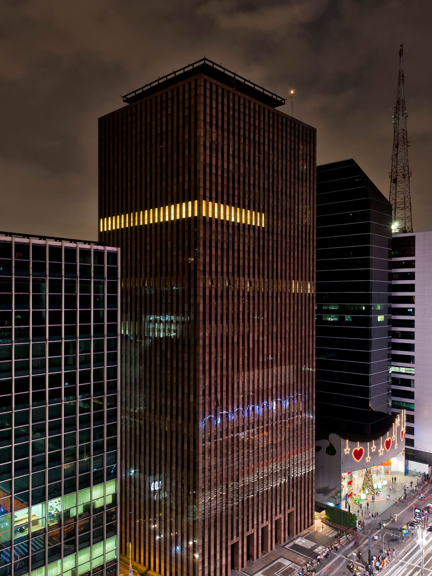 a city street with tall buildings at night