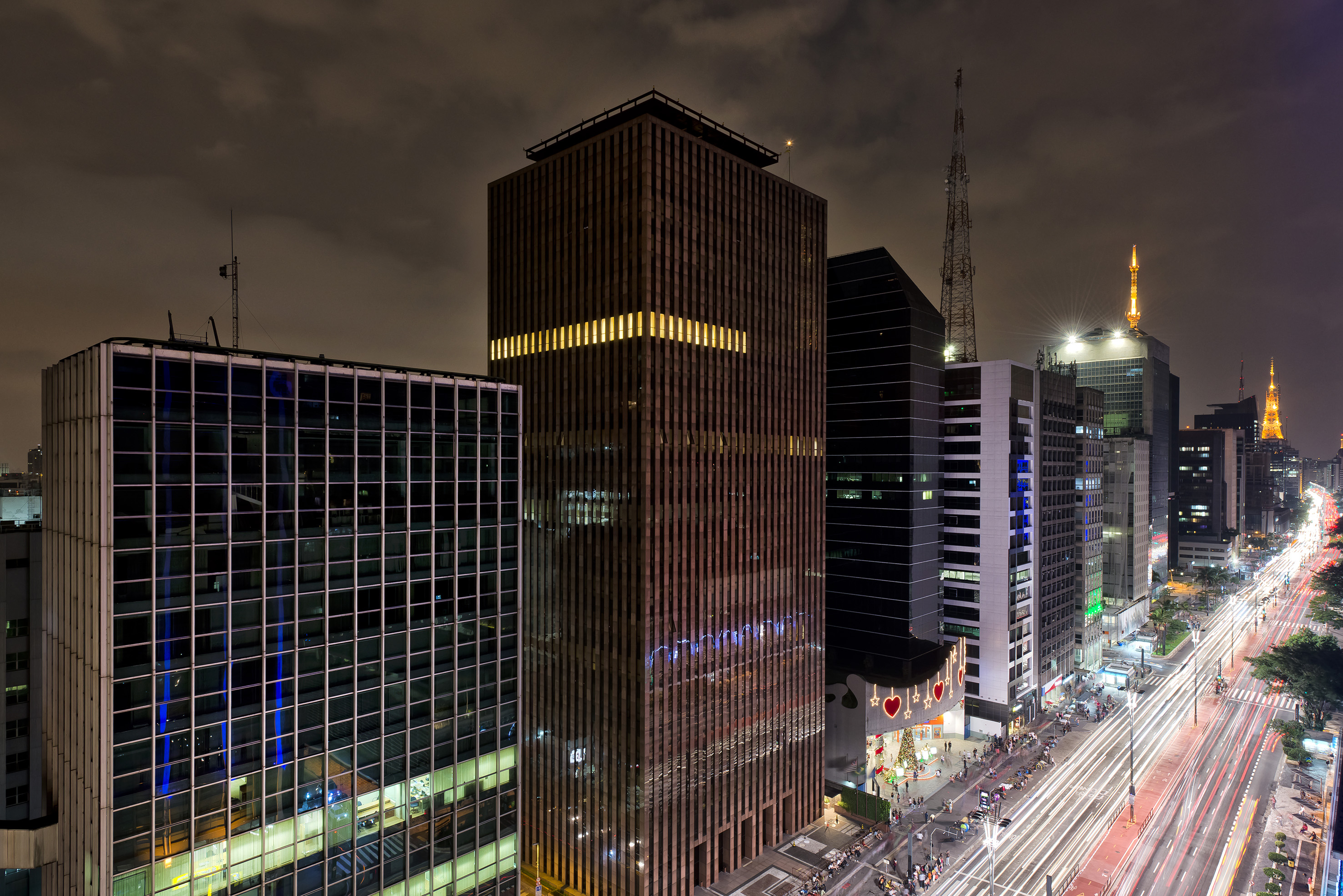 a city street with tall buildings at night