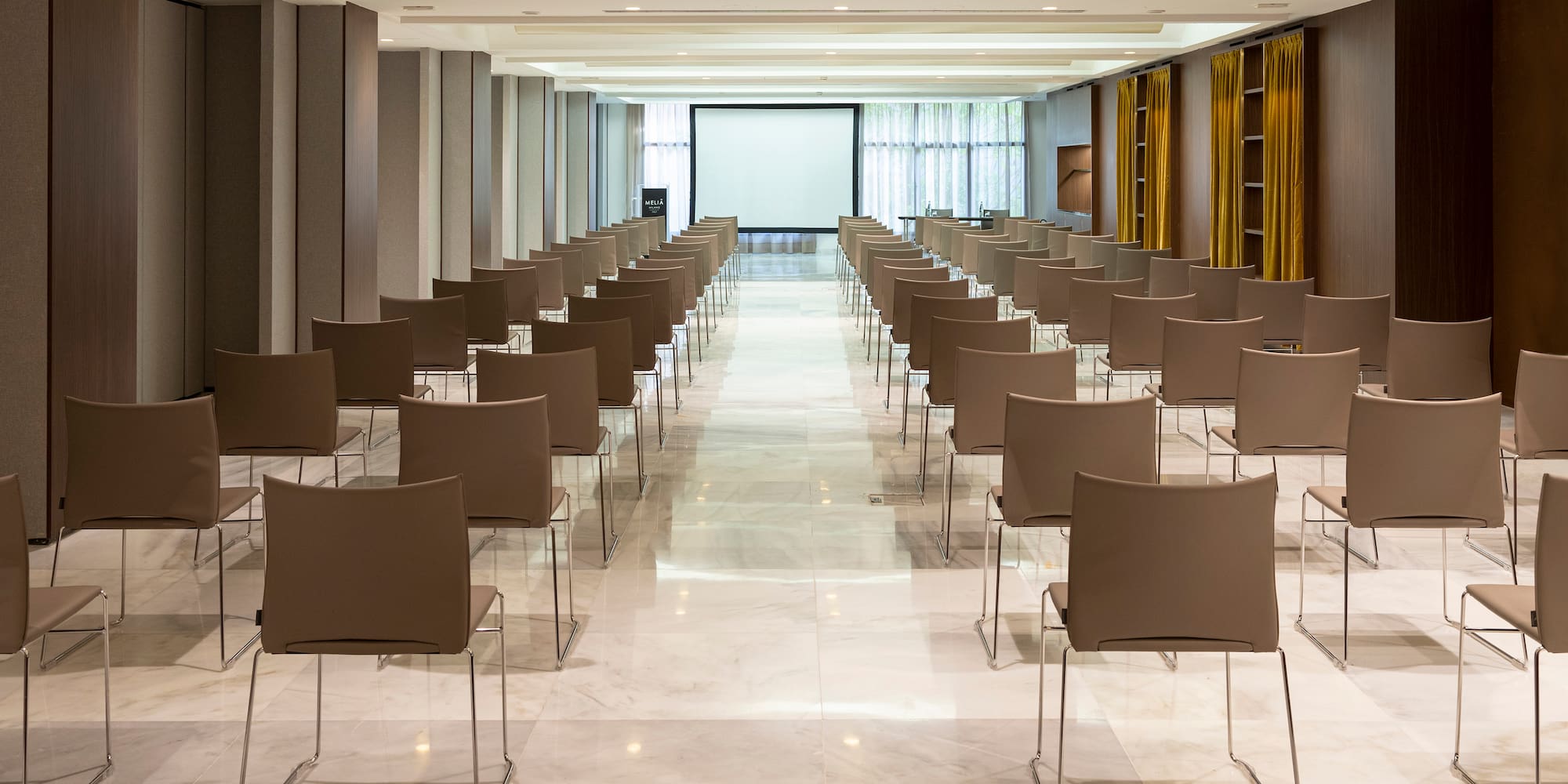 a room with chairs and a projector screen